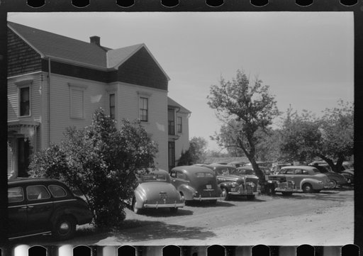 Untitled photo, possibly related to: Cars parked in yard of private home across from Pratt and Whitney, United Aircraft. They charge fifty cents a week or ten cents a day. They have about 400 cars every twenty-four hours. East Hartford, Connecticut