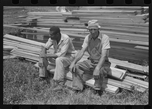Untitled photo, possibly related to: Workers during lunch hour putting up prefabricated defense houses managed by FSA (Farm Security Administration), Hartford, Connecticut