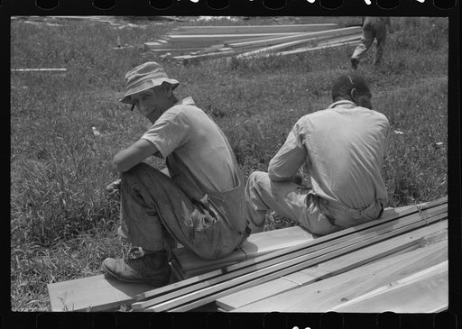 Untitled photo, possibly related to: Workers during lunch hour putting up prefabricated defense houses managed by FSA (Farm Security Administration), Hartford, Connecticut