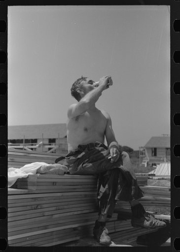 Untitled photo, possibly related to: Workers during lunch hour putting up prefabricated defense houses managed by FSA (Farm Security Administration), Hartford, Connecticut