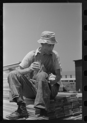 Untitled photo, possibly related to: Workers during lunch hour putting up prefabricated defense houses managed by FSA (Farm Security Administration), Hartford, Connecticut