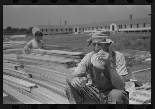 Untitled photo, possibly related to: Workers during lunch hour putting up prefabricated defense houses managed by FSA (Farm Security Administration), Hartford, Connecticut