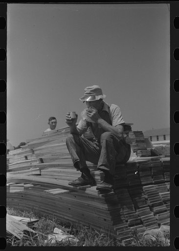 Untitled photo, possibly related to: Workers during lunch hour putting up prefabricated defense houses managed by FSA (Farm Security Administration), Hartford, Connecticut