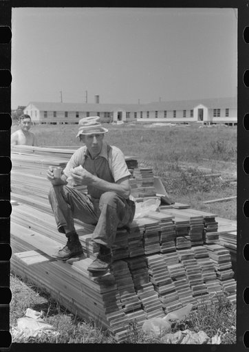 Untitled photo, possibly related to: Workers during lunch hour putting up prefabricated defense houses managed by FSA (Farm Security Administration), Hartford, Connecticut