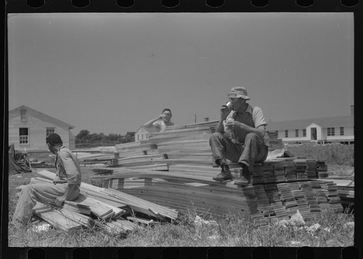 Untitled photo, possibly related to: Workers during lunch hour putting up prefabricated defense houses managed by FSA (Farm Security Administration), Hartford, Connecticut