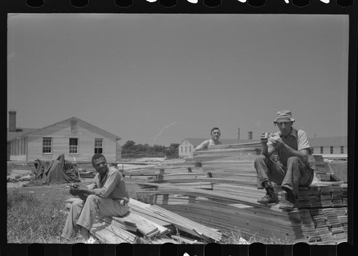 Untitled photo, possibly related to: Workers during lunch hour putting up prefabricated defense houses managed by FSA (Farm Security Administration), Hartford, Connecticut