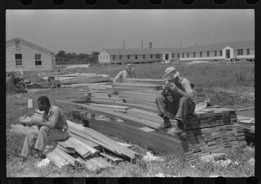 Untitled photo, possibly related to: Workers during lunch hour putting up prefabricated defense houses managed by FSA (Farm Security Administration), Hartford, Connecticut