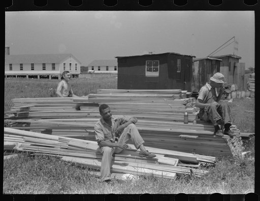Untitled photo, possibly related to: Workers during lunch hour putting up prefabricated defense houses managed by FSA (Farm Security Administration), Hartford, Connecticut