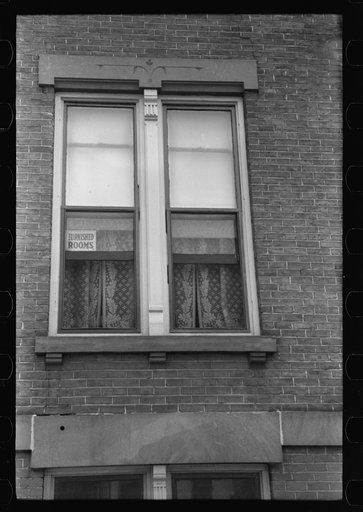 Untitled photo, possibly related to: Signs in window, evidence of boom town and crowded housing conditions. Hartford, Connecticut