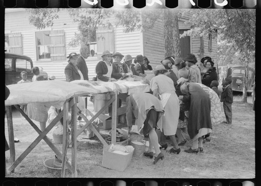 Cleaning up and visiting after outdoor picnic at an all-day ministers and deacons meeting. Near Yanceyville, Caswell County, North Carolina