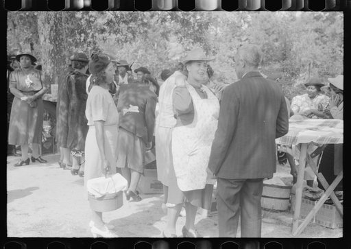 Cleaning up and visiting after outdoor picnic at an all-day ministers and deacons meeting. Near Yanceyville, Caswell County, North Carolina