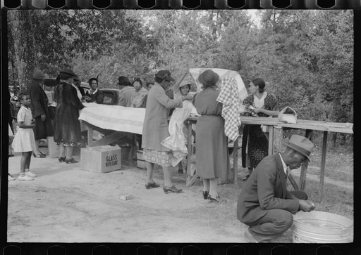 Cleaning up and visiting after outdoor picnic at an all-day ministers and deacons meeting. Near Yanceyville, Caswell County, North Carolina