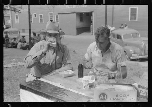 Untitled photo, possibly related to: Brunswick stew dinner in front of the tobacco warehouse on opening day of the auctions. Prepared by Parent Teachers Association of Prospect Hill, to raise money for a new gymnasium for the Prospect Hill Consolidated School in Caswell County, North Carolina