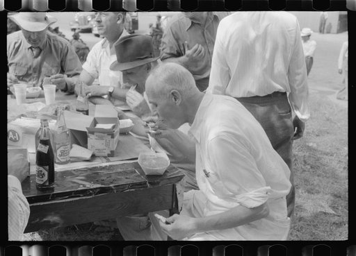 Brunswick stew dinner in front of the tobacco warehouse on opening day of the auctions. Prepared by Parent Teachers Association of Prospect Hill, to raise money for a new gymnasium for the Prospect Hill Consolidated School in Caswell County, North Carolina