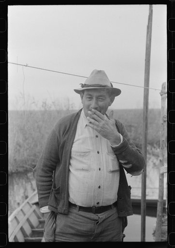 Untitled photo, possibly related to: Spanish muskrat trappers by their marsh camp in bayou near Delacroix Island, Louisiana