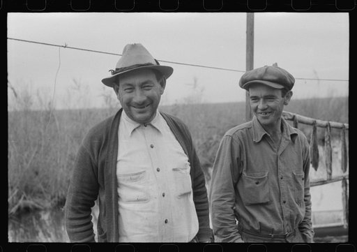 Spanish muskrat trappers by their marsh camp in bayou near Delacroix Island, Louisiana