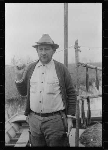 Spanish muskrat trapper by his marsh camp, near Delacroix Island, Louisiana