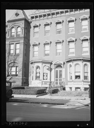 View showing tailor shop carved into brick building, another example of "blight." Washington, D.C.