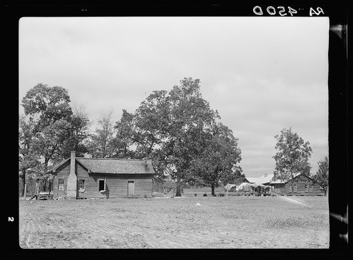 Old house to be vacated by resettled family on left. New house at right. Wolf Creek Farms, Georgia