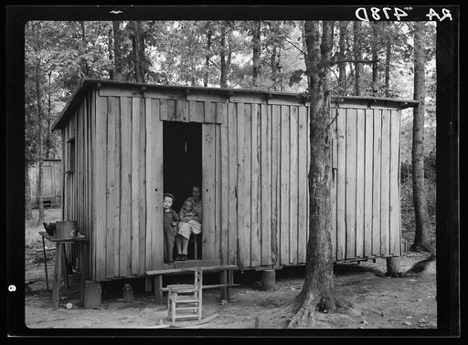 Family of resettled farmer living in temporary shack while new house is being built. Skyline Farms, Alabama