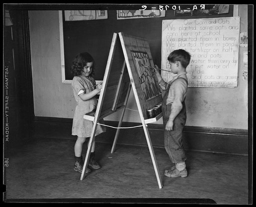 First grade boy and girl at drawing board in schoolroom. Reedsville, West Virginia