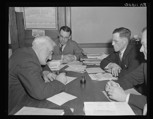 Farmer signing agreement with farmers' production cooperative. Coos County, New Hampshire