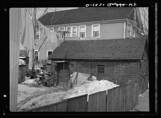 Garage in foreground is home of white family, man and wife. Manville, New Jersey