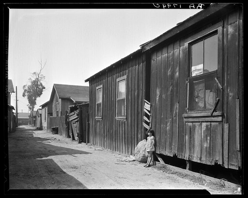 Mexican quarter of Los Angeles. One quarter mile from City Hall. Area has been condemned and will be torn down shortly to make space for the new Union Railroad station. Average rent is eight dollars