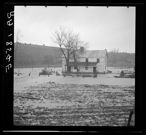 A low-lying farm being slowly engulfed by the rising waters of a West Virginia stream
