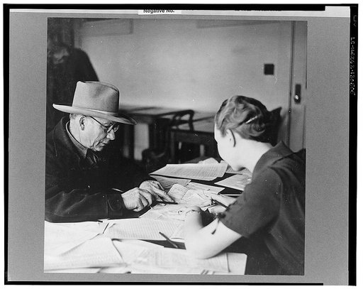 Farmer signing a wind erosion agreement. He will receive twenty cents an acre for listing a certain percentage of his total acreage. Dodge City, Kansas