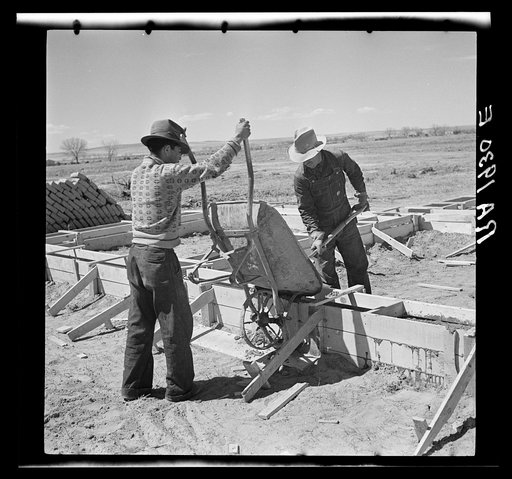 Laying the foundations for one of the adobe houses. Bosque Farms, New Mexico