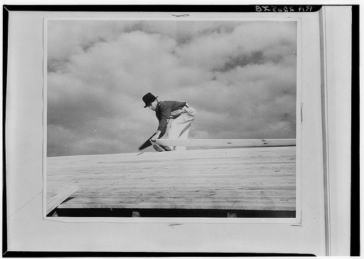 Carpenter working on the roof of the first shelter near the lake site of the Berwyn project, Maryland