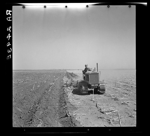 A farmer listing his fields under the wind erosion control program. He receives twenty cents an acre for the work. Liberal, Kansas