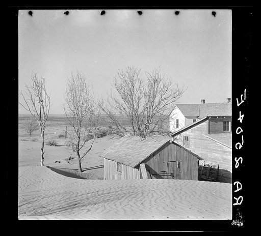 Soil blown by "dust bowl" winds piled up in large drifts near Liberal, Kansas