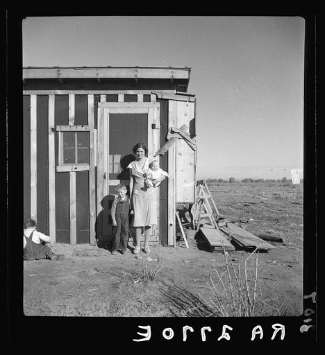 Resettled at Bosque Farms project. Family of four from Taos Junction shows temporary dwelling