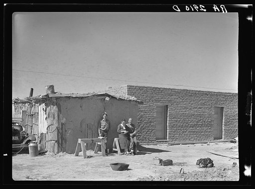 Rehabilitation clients. Mexican jacal on left in which they formerly lived and new houses built through Resettlement Administration loan. Dona Ana County, New Mexico