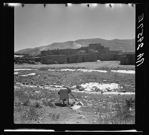 Indian women still fetch water from the Rio de Taos, which runs through the Pueblo village. New Mexico