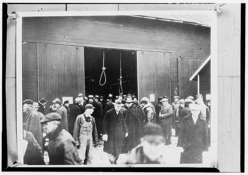 Two hangman's nooses hang as a grim warning to prospective bidders on this foreclosed farm. In this way many farms sold for only a few cents until the Farm Debt Adjustment Committee came into being