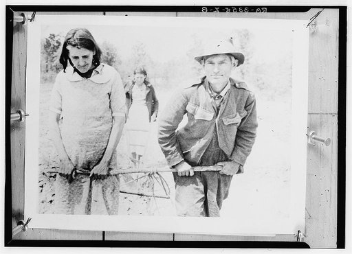Paul J. Green and his wife and one of their daughters showing the way they worked their small plot in 1935 and the two preceding years before they received their horse from the Rural Settlement Administration, which they are using to work the land this year. A son makes up the fifth member of the fa