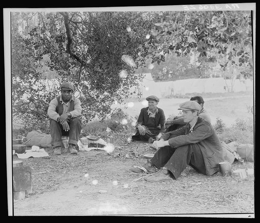 Camp of single men by the roadside. They have come in to work in the pea fields. Nipomo, California