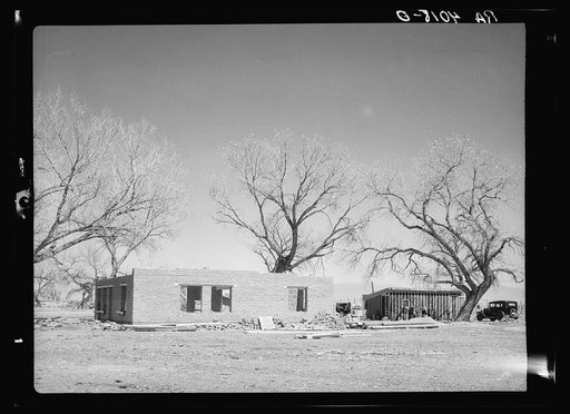 New adobe house. Temporary house in background. Bosque Farms, New Mexico