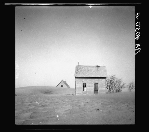 Sand whirling around house and barn. Cimarron County, Oklahoma
