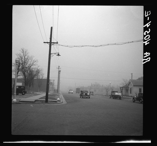 Autos have to turn on lights to penetrate gloom of dust storm. Amarillo, Texas
