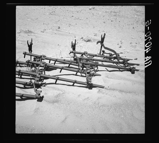 Dust covering farm implements. Castro County, Texas