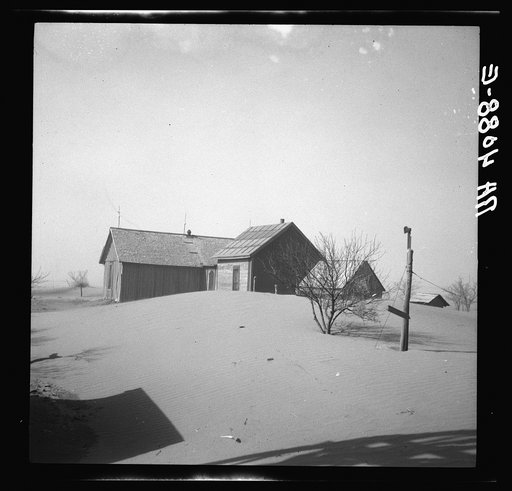 Dust piled up around farmhouse. Oklahoma