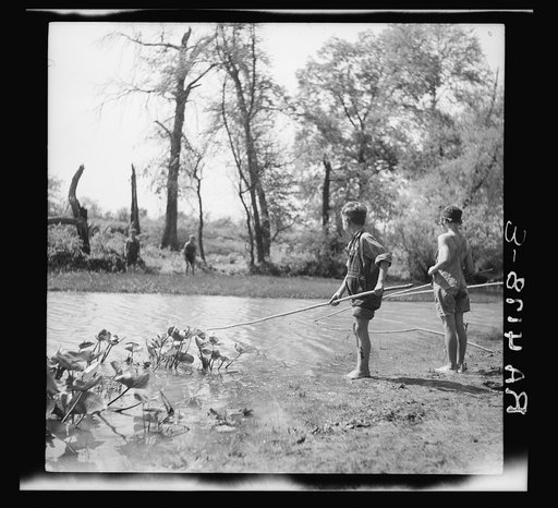 Rehabilitation client's children fishing in creek. Cherokee County, Kansas