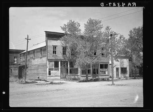 A ghost town decaying as a result of drought and low farm produce prices.  Ardmore, South Dakota