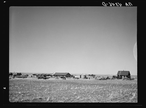 Home of wheat farmer-speculator. Cheap house and heavy investment in machinery. Box Butte County, Nebraska
