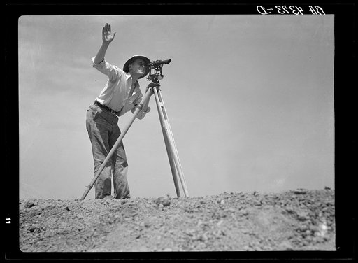 Surveyor on stock water dam. Pine Ridge land use project. Sioux County, Nebraska