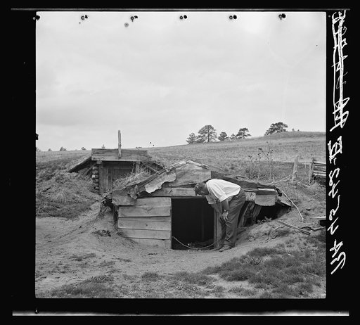 New storage dugout built by rehabilitation client. Old one in foreground. Sioux County, Nebraska